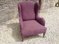 Antique low wing chair by Howard and Sons.jpg